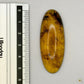 Cabochon en ambre jaune du Mexique, forme ovale, avec des inclusions naturelles et une finition polie. Présenté avec une règle pour référence